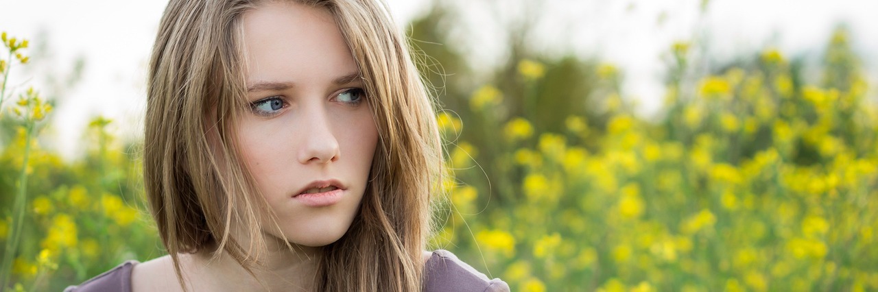 young woman looking worried outside