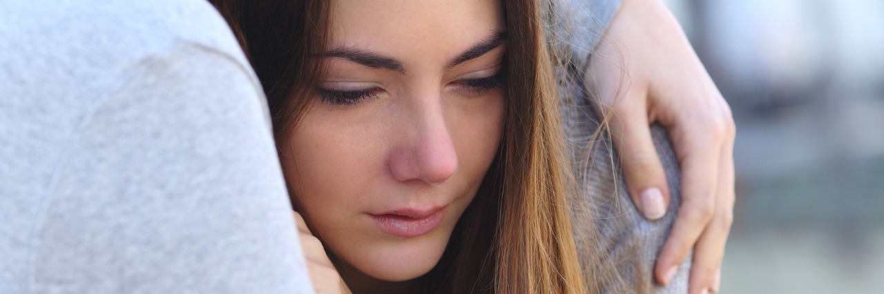 How to Love Someone With Mental Illness sad girl crying and a friend comforting her