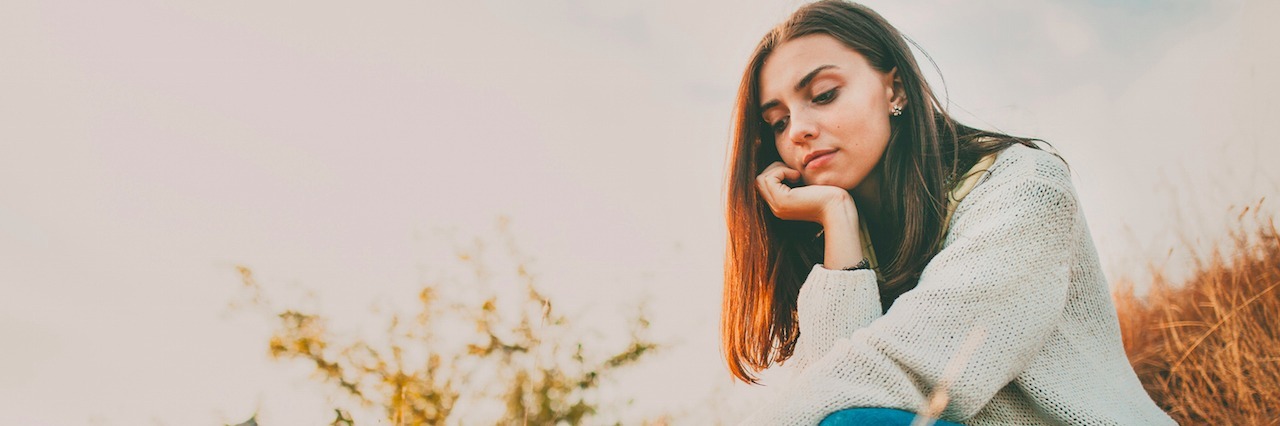 What It's Like to Be Anxious With a Laid-Back Personality A young girl sitting among reeds in the water