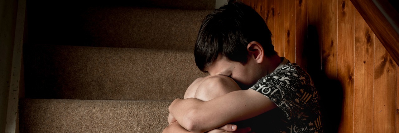 I Cannot Understand How My Son's Suicide Affects His Little Brother Boy Crying Sitting on Stairs