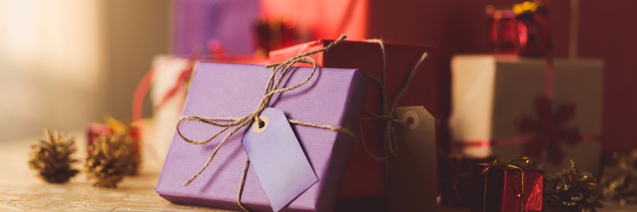 10 Gifts to Give Someone With Chronic Pain Pile of Christmas presents and gift boxes