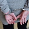 Arrested woman in handcuffs behind her back