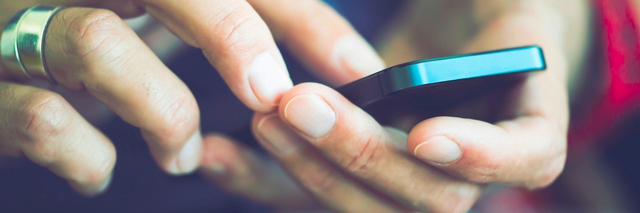 Why Social Media Triggers My Depression close up of a woman on her phone