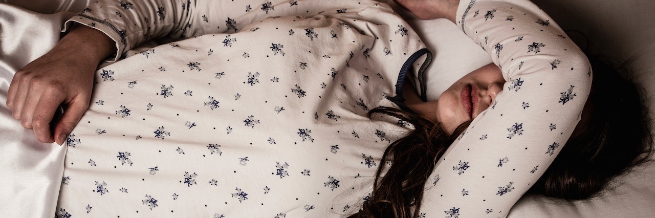 Major Depressive Disorder: Why I Didn't Get Out of Bed Today woman lying in bed, looking sick