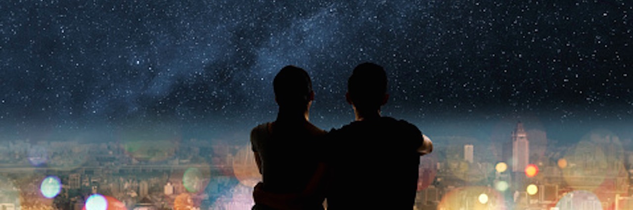 young couple looking at starry sky