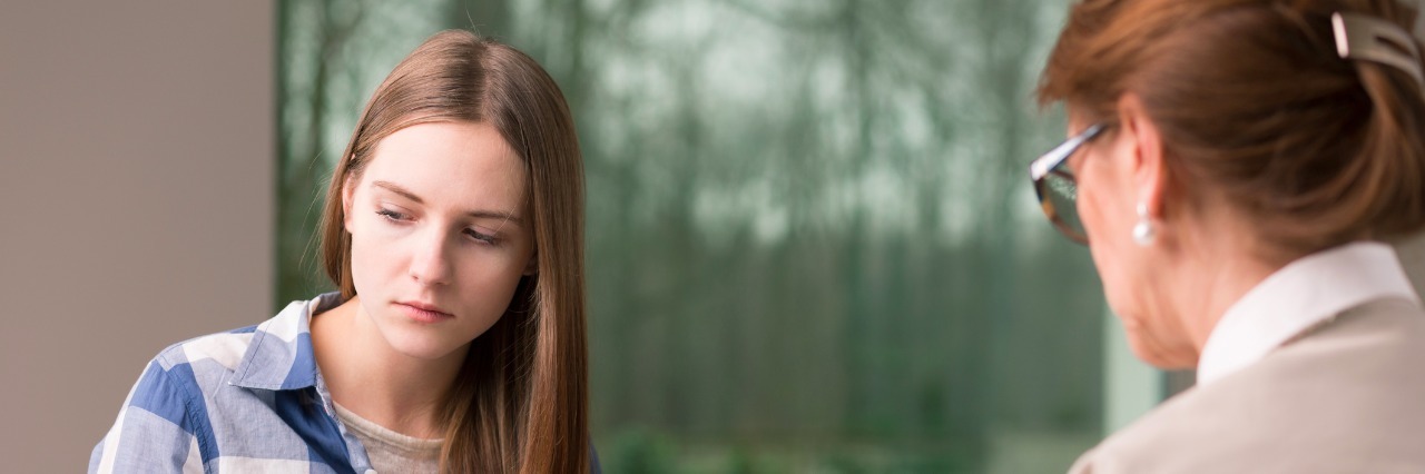 Letter to Therapist Who Told OCD Patient to 'Just Stop It' young sad woman sitting across from therapist taking notes