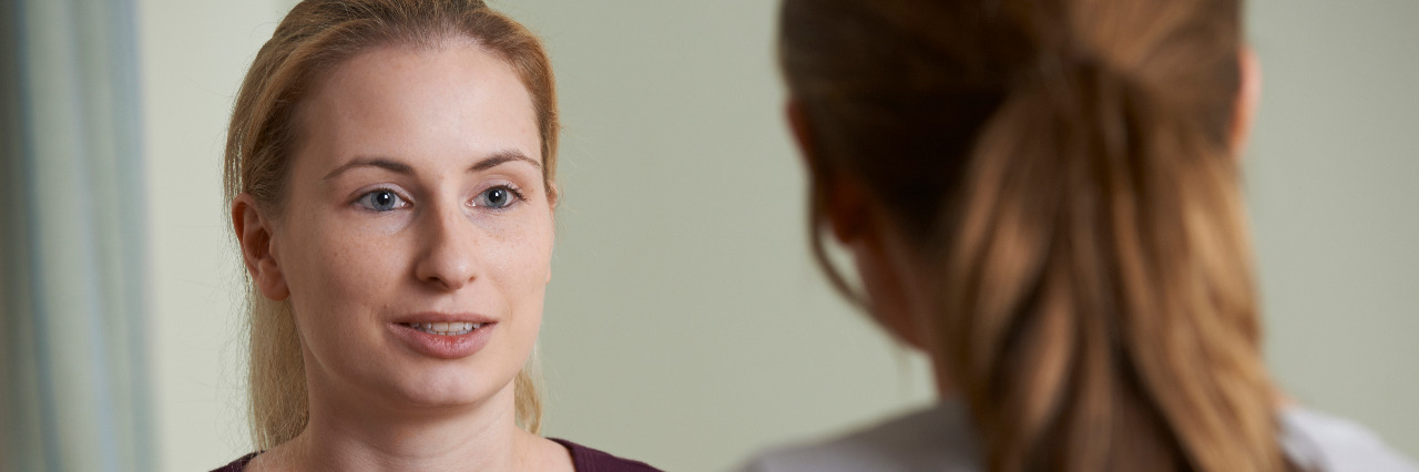 The Benefits of Telling Others About My Epilepsy Woman talking to a friend.