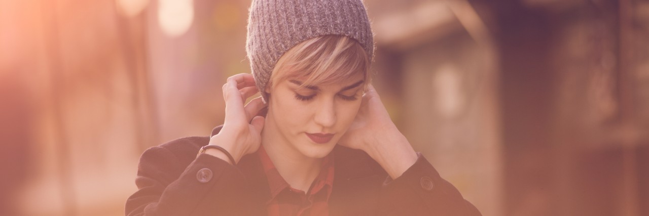 4 Life Lessons I've Learned From Having Ehlers-Danlos Syndrome young woman putting cap on her head