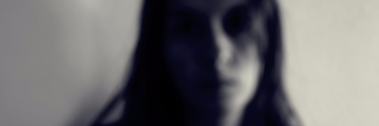 What I Can't Say When You Ask, 'What's Wrong?' black and white out of focus portrait of young woman with dark hair