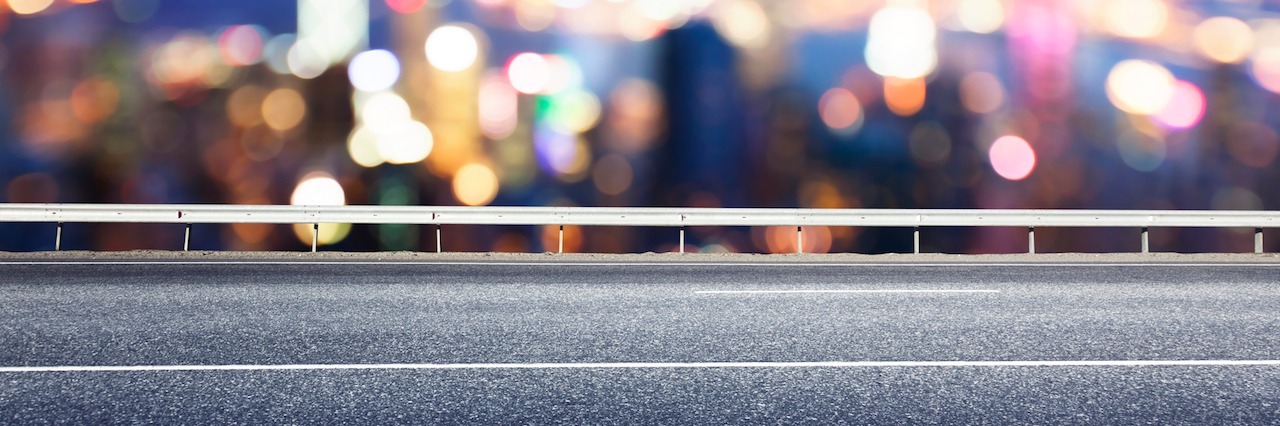 What It Feels Like to Have a Panic Attack in the Car highway with a blurred city in the background