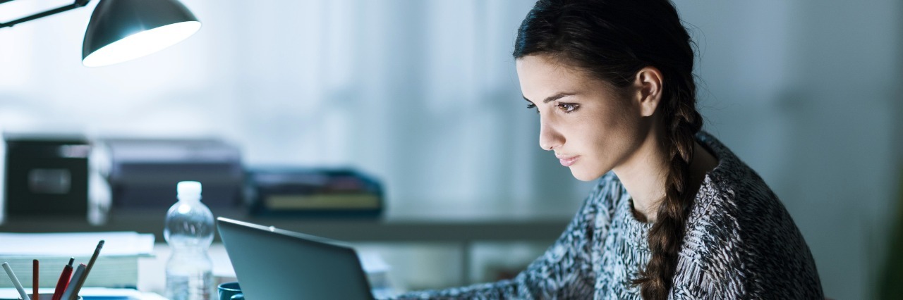 Student Responds to Classmate Who Imitated Stuttering girl working on laptop
