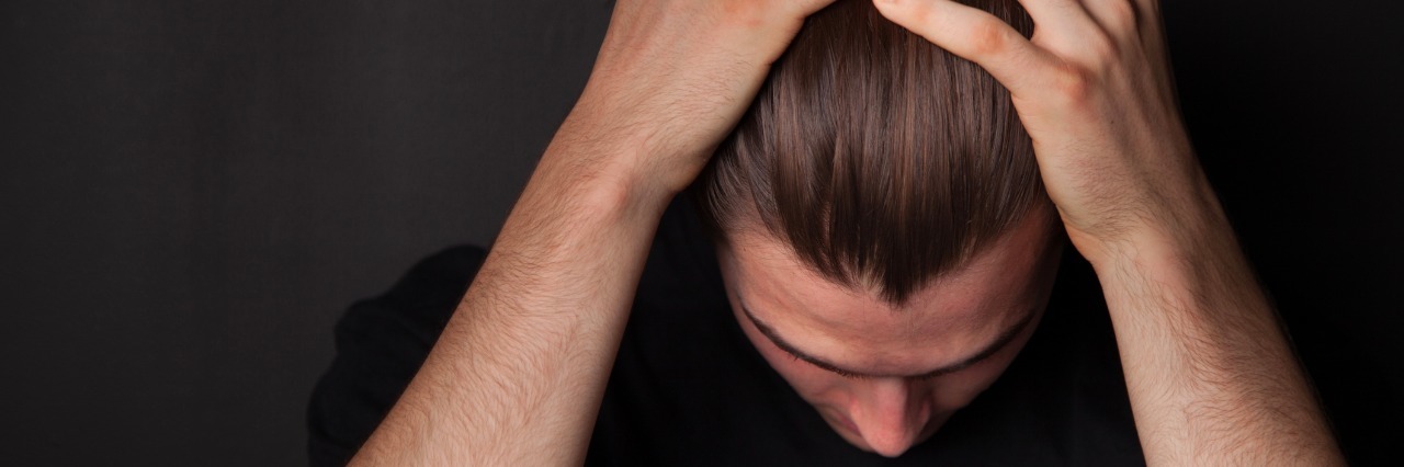 Why Being Nice Can Trigger PTSD young man running his hands over his hair in frustration