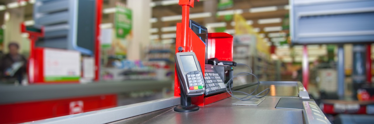 Cash desk with payment terminal in supermarket