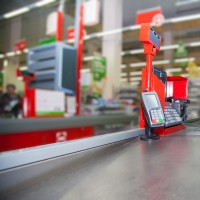 Cash desk with payment terminal in supermarket