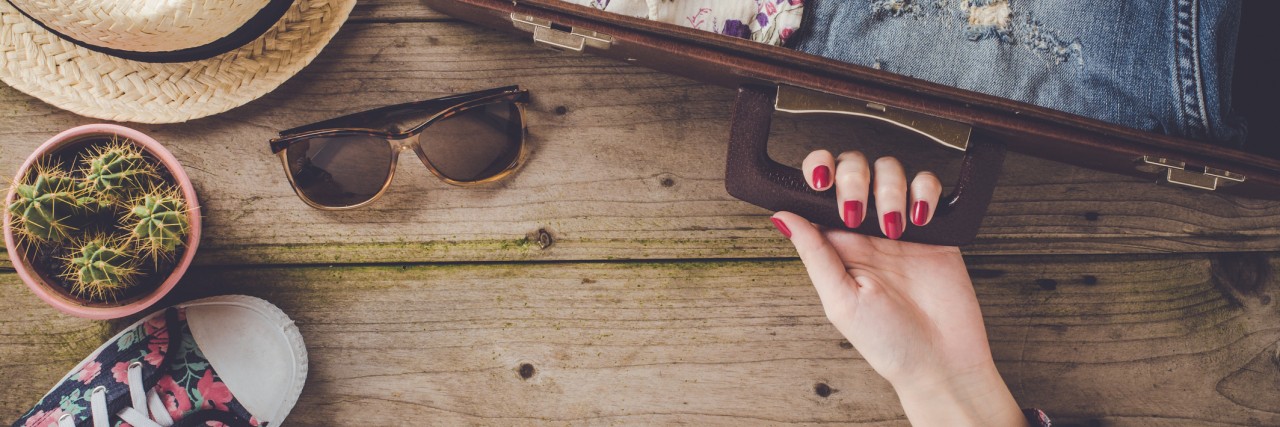 10 Packing Tips for People With Fibromyalgia and Chronic Pain Travel preparations on wooden table