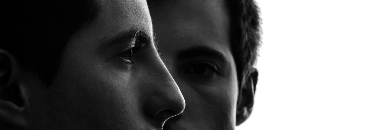 Personality Disorders: Living With Another Inside Your Brain close up portrait two young men in shadow white background