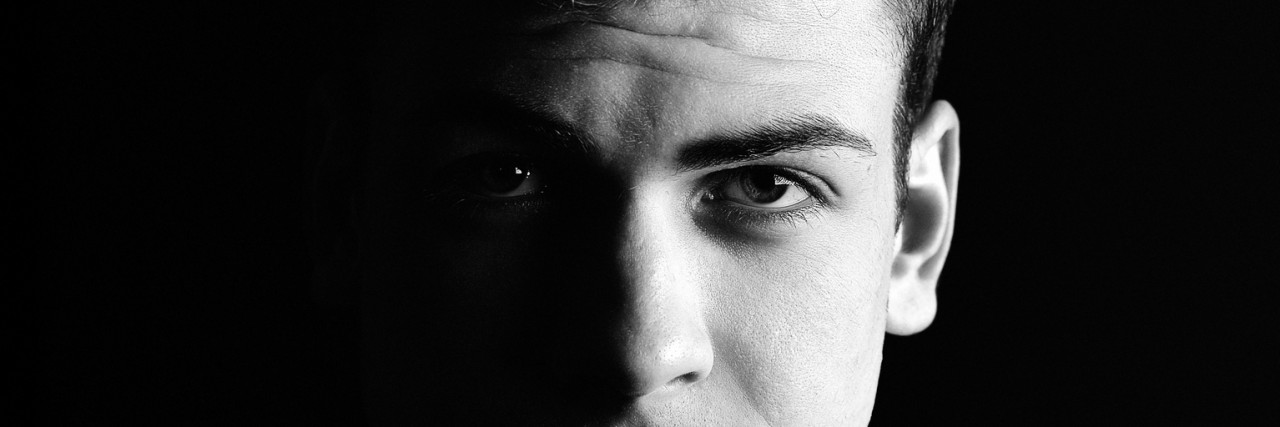half-face young man portrait in low-key