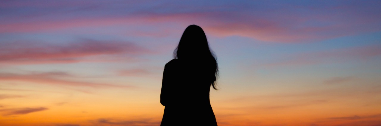 Celebrating Small Victories With Complex PTSD Silhouette of woman facing sky at sunset or sunrise