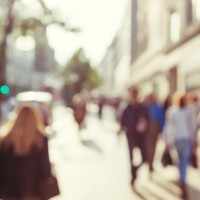 Blurry photo of people walking on city street