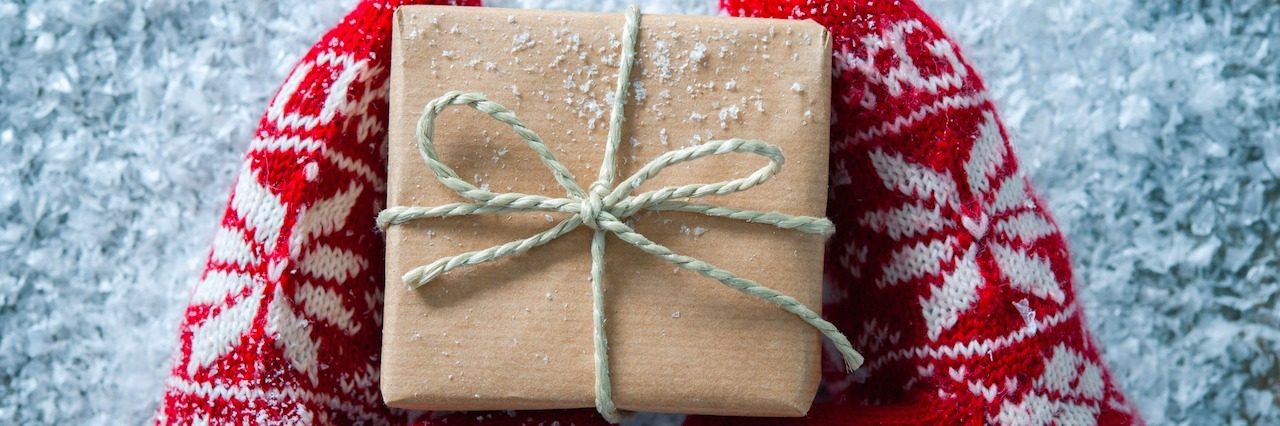 10 Gift Ideas for Your Loved One With Depression and Anxiety A gloved hands holding a package in the snow
