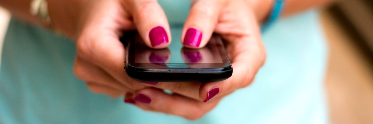 Simple Message Helps Young Woman With Suicidal Thoughts girl holding smart phone outside