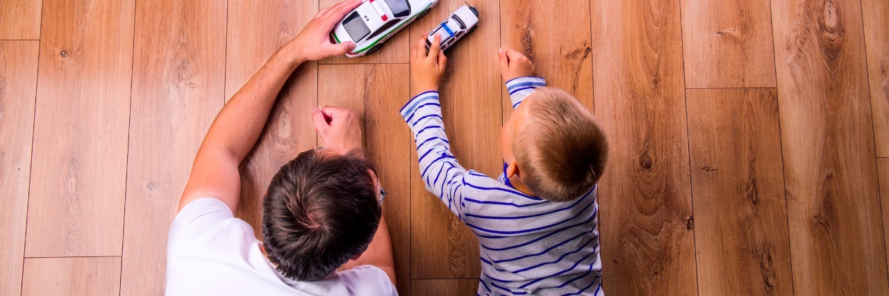 What I'm Thankful For as a Dad to a Son With Phelan-McDermid Syndrome Unrecognizable father with his son playing with cars