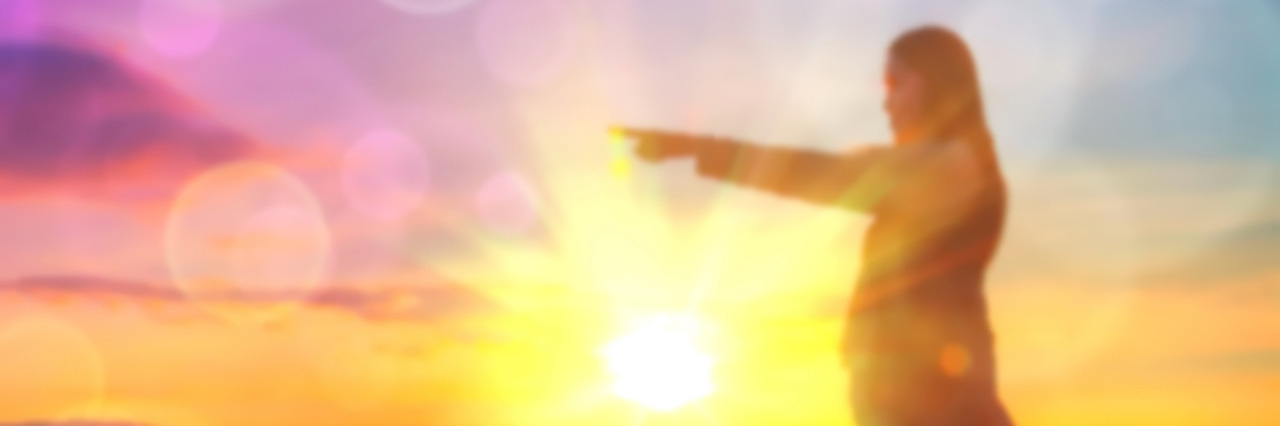 A Letter to Anyone Who's Struggling With a Mental Illness Abstract Blurred and soft photo of Women on hilltop with bokeh of sunrise on the natural background