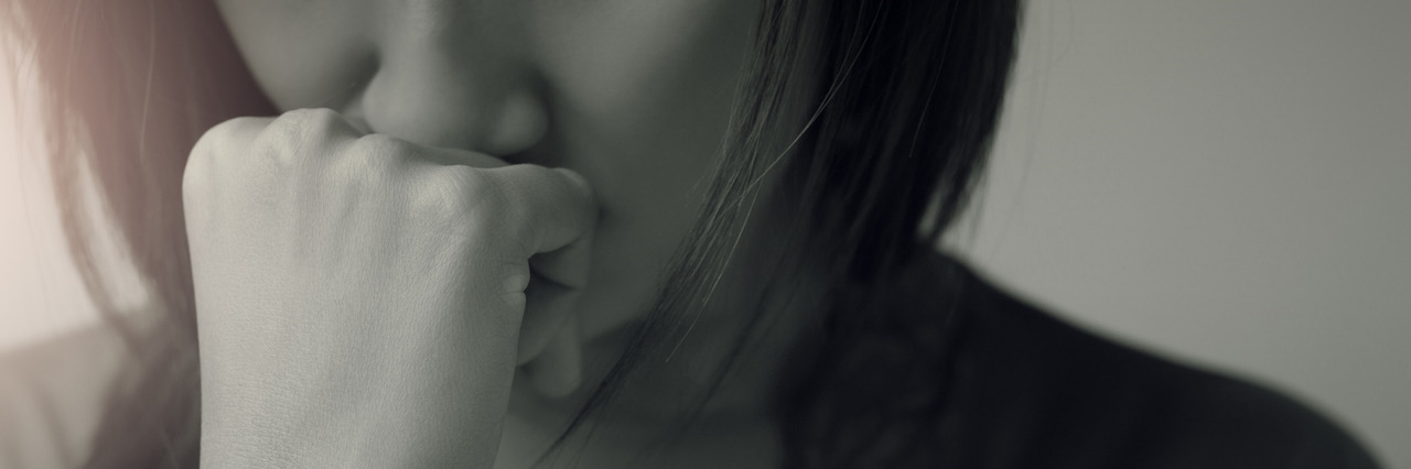 What a Panic Attack Is Like and What to Do to Help Sad woman with fist to chin