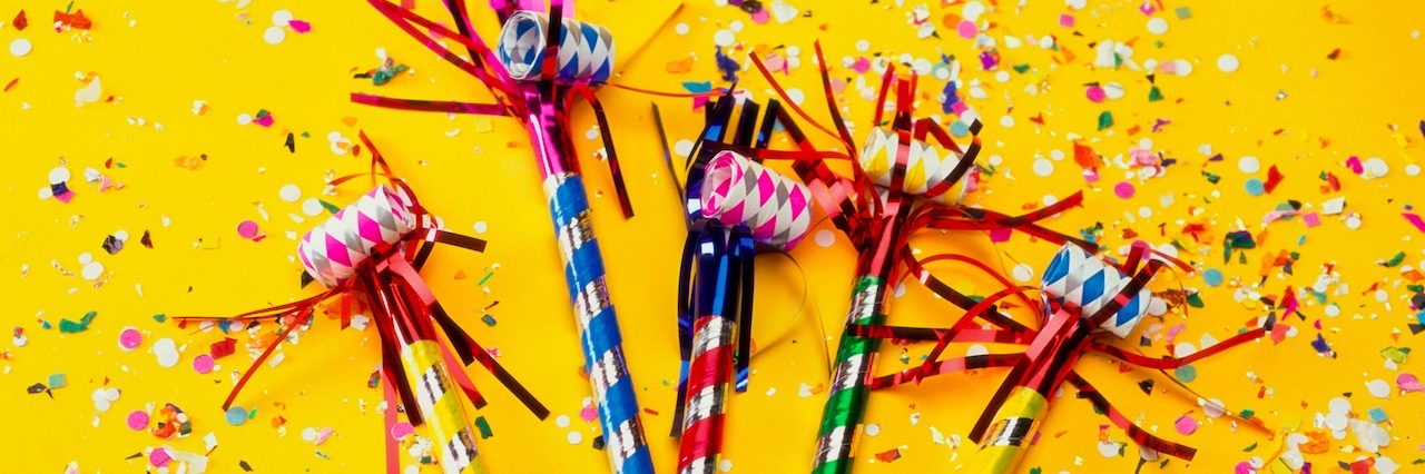 New Year's Resolutions for Someone With Anxiety Party horn blowers and confetti