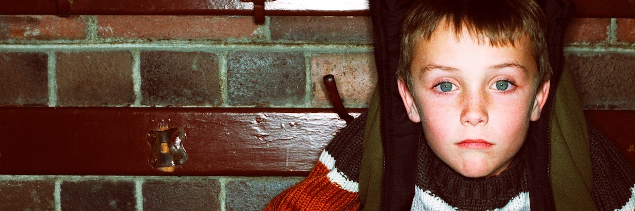 Standing Up to the Bullies That Are Depression and Anxiety young boy attached to a coat hook by his jacket