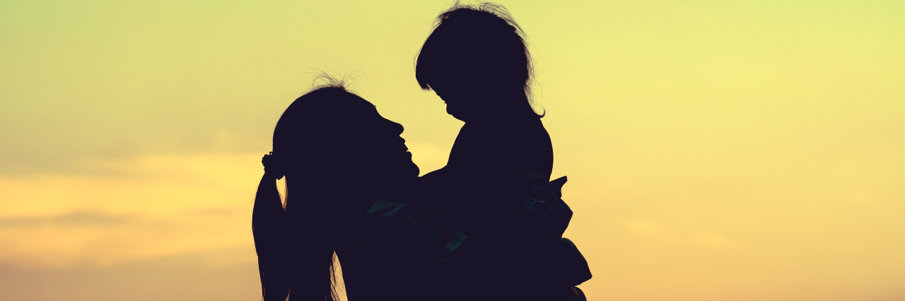 Silhouette of mother and daughter.