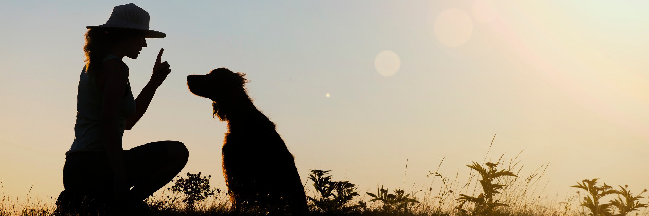 Responding to Discomfort With Invisible Disabilities Woman training dog.