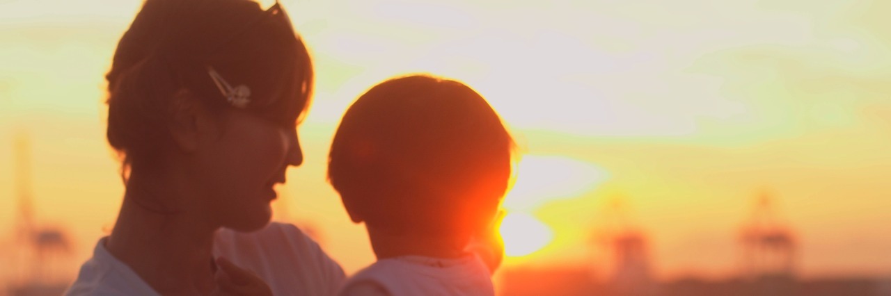 Don't Be Sorry About My Son's Feeding Tube portrait of mother and child to back the sunset