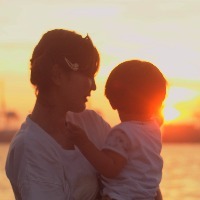 portrait of mother and child to back the sunset