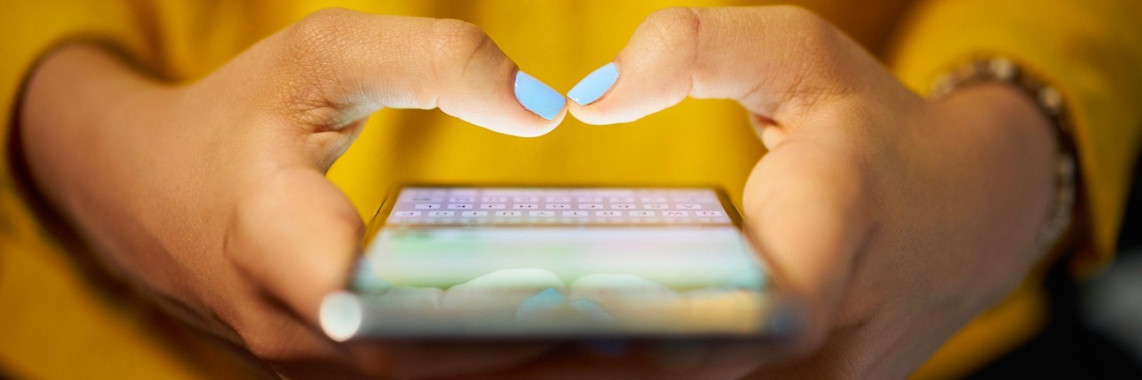 Depression: Why I'm Not Sharing My Facebook 'Year in Review' Video a young woman typing in her phone