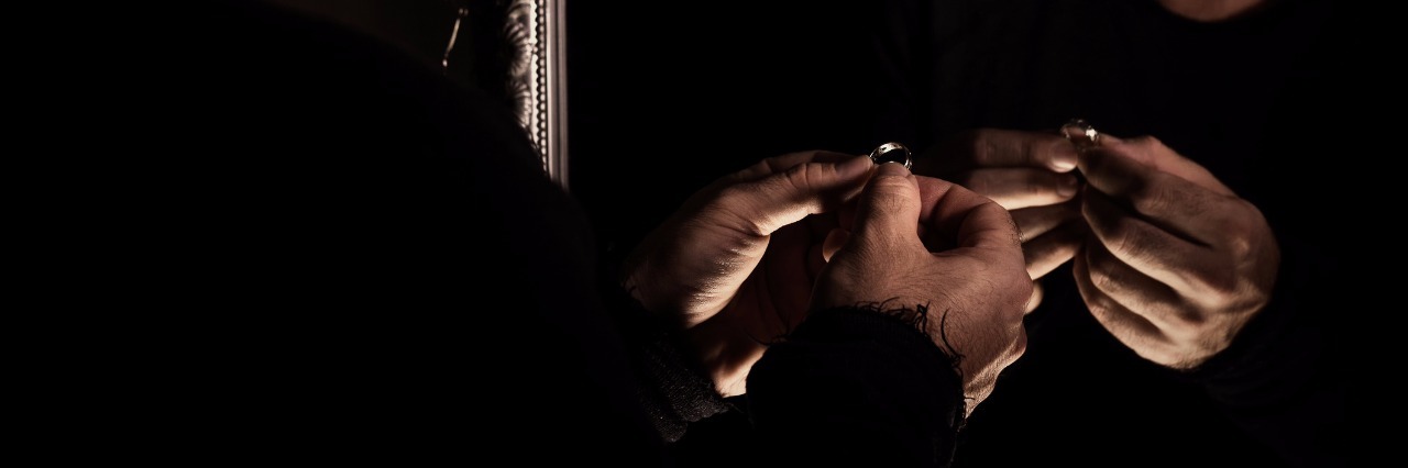 Experiencing Loneliness After the Loss of a Spouse man in despair sad and lonely looking at wedding ring