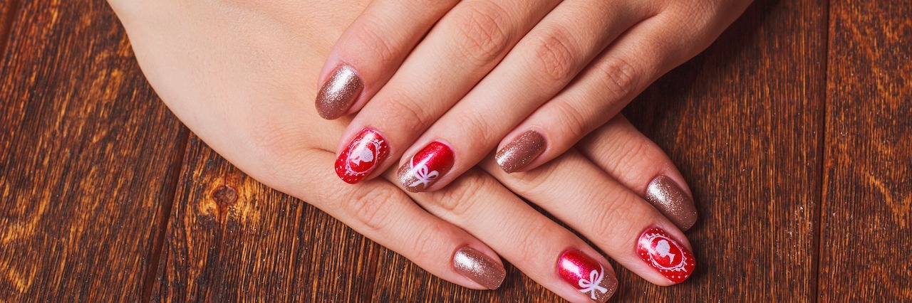 What It's Like to Have Contamination OCD at Christmas A woman with festive nails.