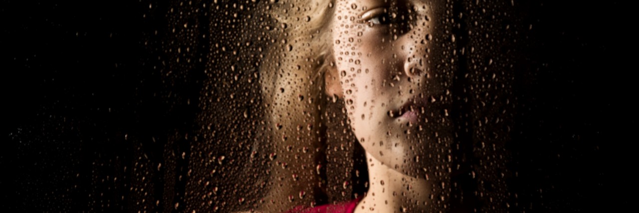 When You're Afraid of Life With Mental Illness lonely young sad girl behind the window with drops
