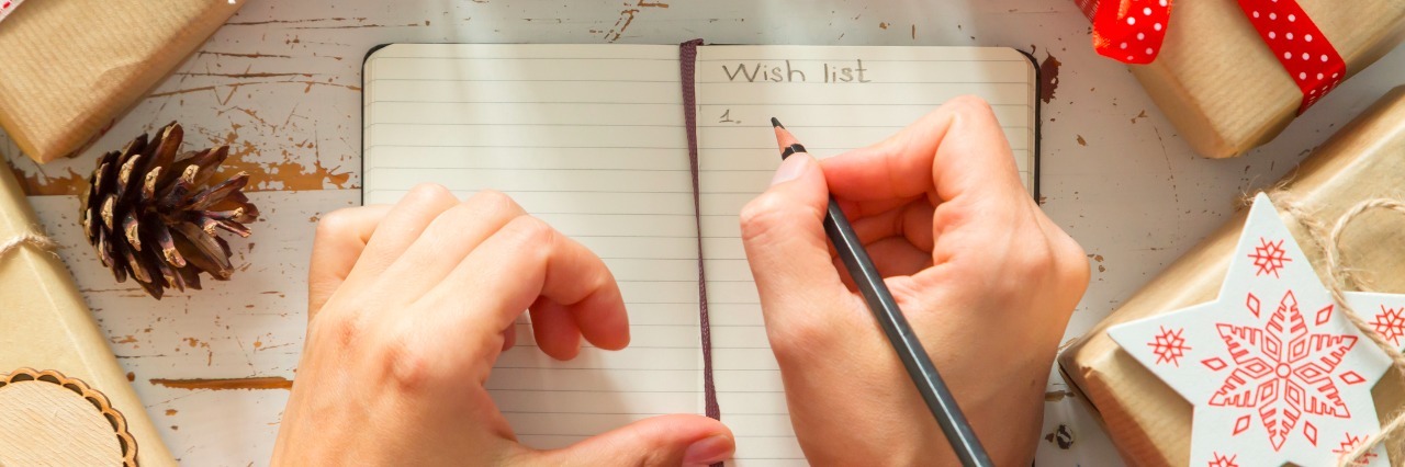 Wish List to Santa By Someone With Kidney Disease Making list of presents on wood background, copy space