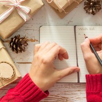 Making list of presents on wood background