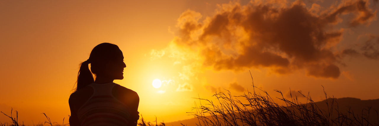 What I Have Learned From 2016 Woman watches the beautiful sunset/sunrise.