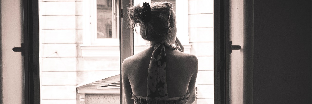 Dealing With Grief After My Gatroparesis Diagnosis Sepia, black and white, woman in the window