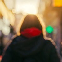Blurry photo of woman walking on city street