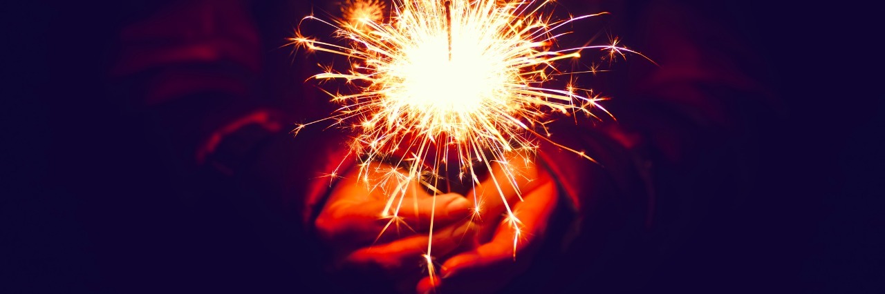 Rare Disease: New Years Misconceptions festive christmas sparkler in hand