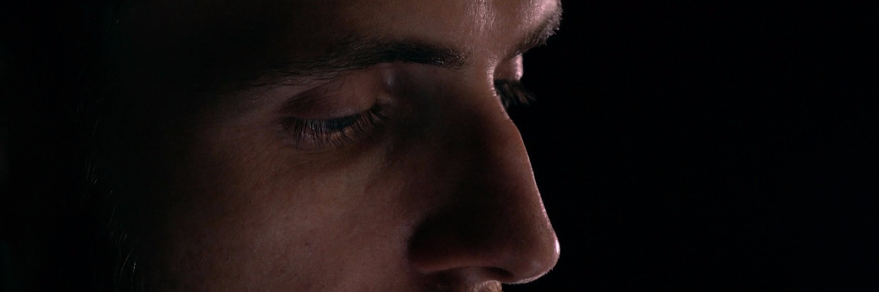 Advice for Myself as a Teen With Schizoaffective Disorder Profile view of focused intelligent bearded young man using his