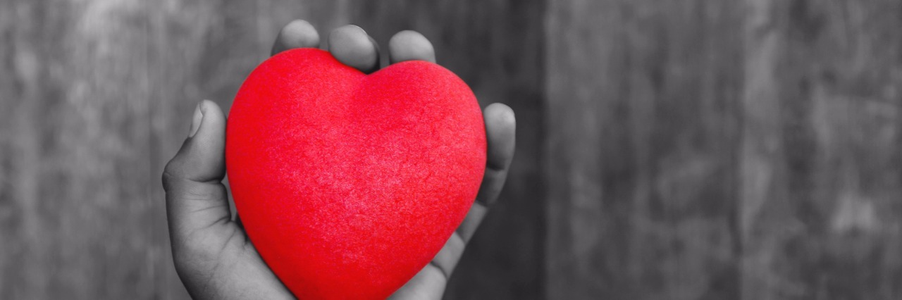 4 Things I Want the People Who Support Me With Mental Illness to Know man hand hold a red heart