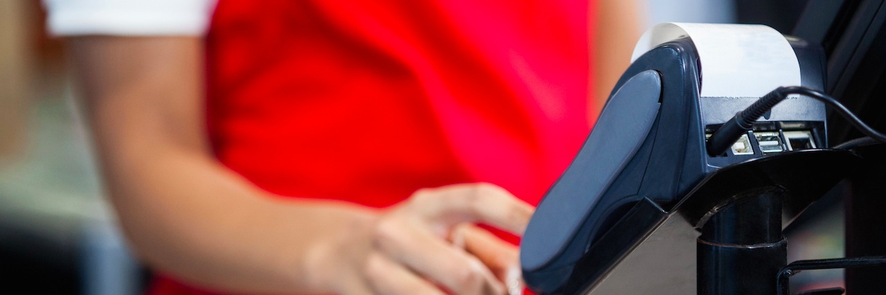 To the Cashier Who Realized I Was Having a Panic Attack cashier swiping a credit card