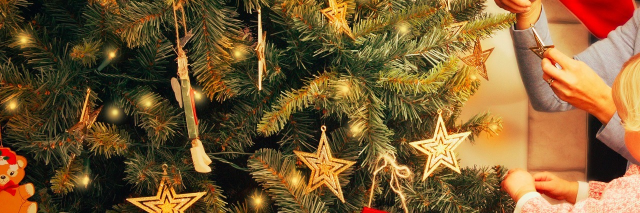 Tips for Special Needs Families Celebrating the Holiday Season Mother and child decorating a Christmas tree