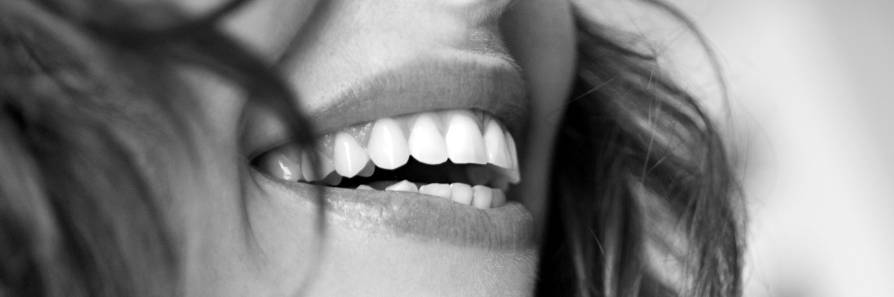 Hiding the Monster of Anxiety Behind a Fake Smile Smiling woman