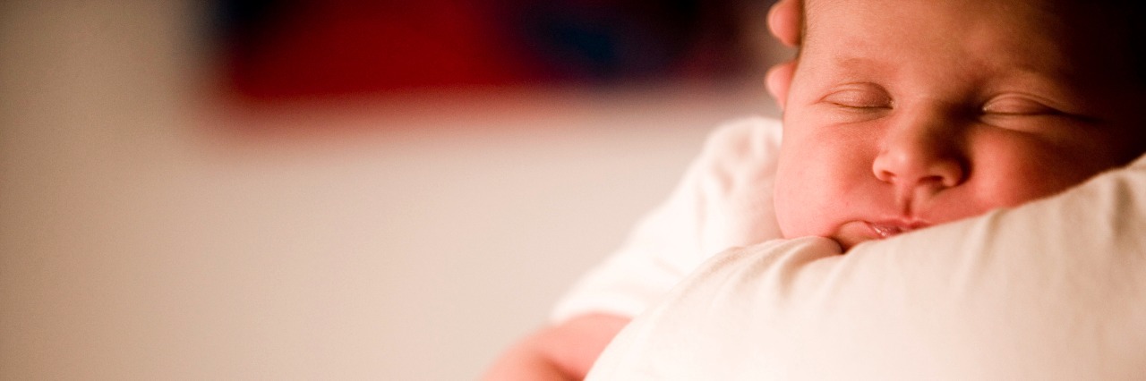 Postpartum OCD: What I Wish I Knew close up of mother holding baby